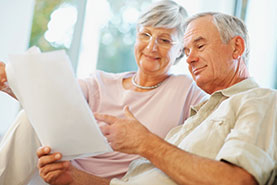 Photo of a couple looking at papers. Link to Closely Held Business Stock.