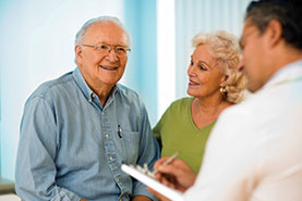 Photo of a doctor talking with a patient and his wife. Link to Gifts by Will.
